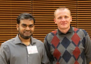 two men stand next to each other