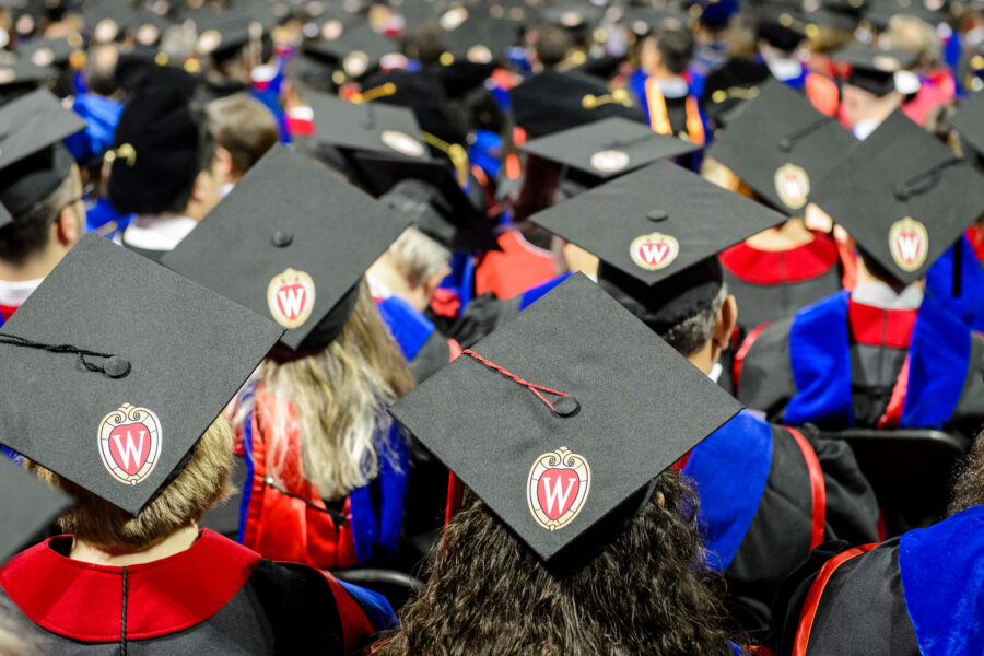 a crowd of people wearing graduation caps