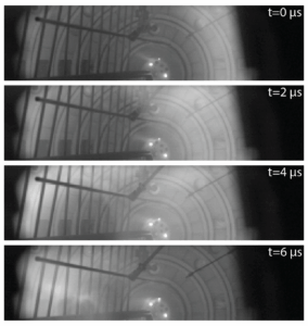 4 panels of images from the same spot inside a piece of research equipment show how the experiment changes over time, from 0 to 6 microseconds