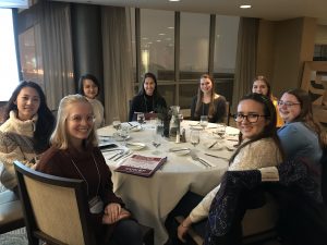 UW undergrad women at a table during the conference dinner