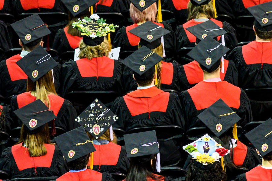rows of graduates in regalia, sitting in chairs