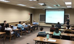 a conference room with students viewing a professional development presentation