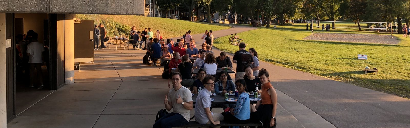 students in a park eating at tables
