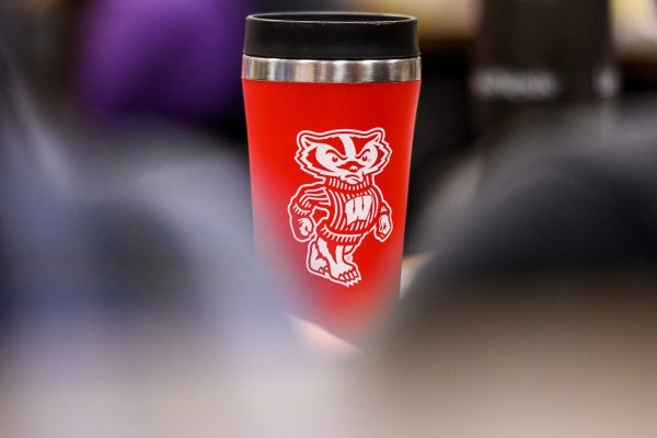 a red coffee tumbler with Bucky Badger on it