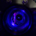 a blue-laser-hued image of a trapped ball of strontium ions in an optical lattice clock