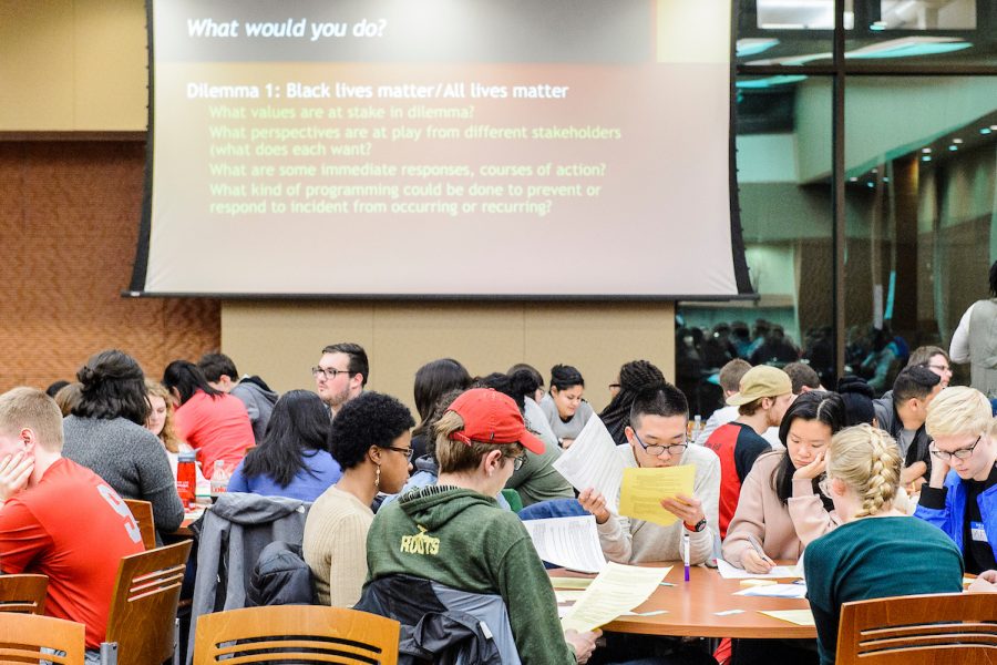 several people sit at tables during a workshop