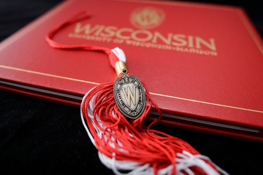 A graduation tassel with a pendant of the W crest is pictured