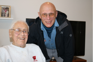 Barney is seated on the left and Ray is to Barney's left, crouched down to pose for the photo