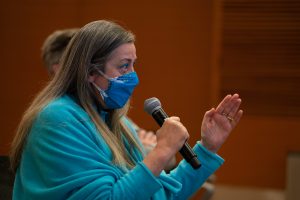 a woman speaks into a microphone