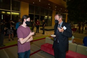 prof. bergmann on the right, talking to a woman on the left