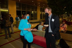a woman and a man face each other and talk