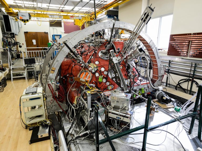 a large metal sphere, painted red, with wires and probes and tubes coming in and out of it