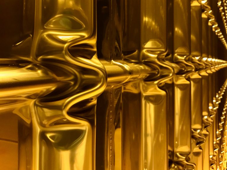 a gold swirl of metallic tubing