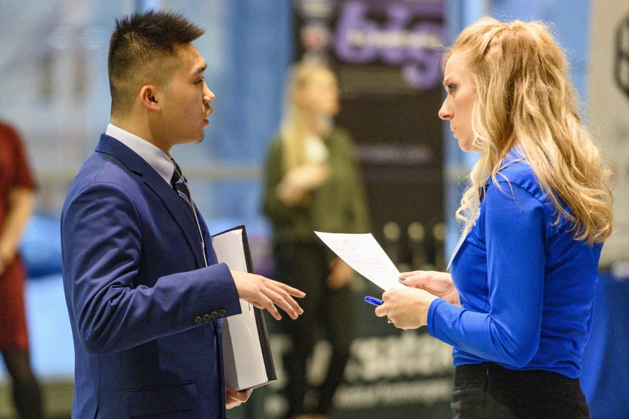 UW undergraduate Alvin Lee (left) talks with a recruiter during the annual Spring Career and Internship Fair held at the Kohl Center at the University of Wisconsin-Madison on Feb. 5, 2019. The fair featured 215 employers and was open to all current students and alumni. (Photo by Bryce Richter /UW-Madison)