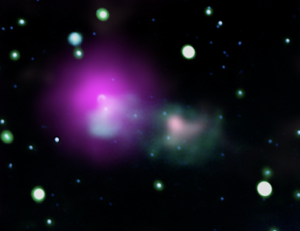a mostly black image of space, with some small white-ish out-of-focus stars, and a large fuzzy pink blob partially overlapping a green-hued amorphous apparition
