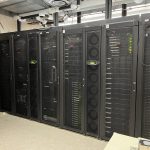 a long row of stacked computer servers