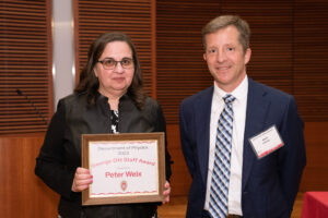 a man on the right with a woman on the left holding an award