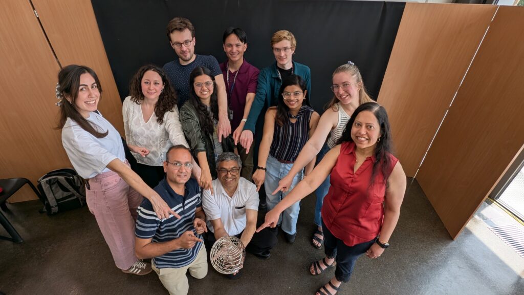 a group of people pose with a trophy-like object