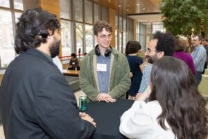 four people stand around a table and chat
