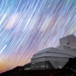 an observatory on top of a hill with "movement" of stars captured on a long exposure