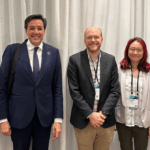 5 people dressed in business attire stand to pose in a line