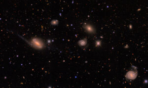 a mostly black background (deep space) dotted with (relatively) small stars and galaxies