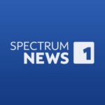 blue logo with white text that says "Spectrum News 1"