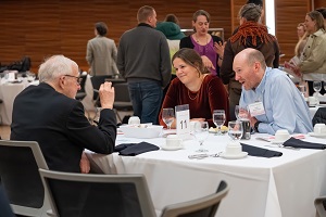 people sitting around a dinner table